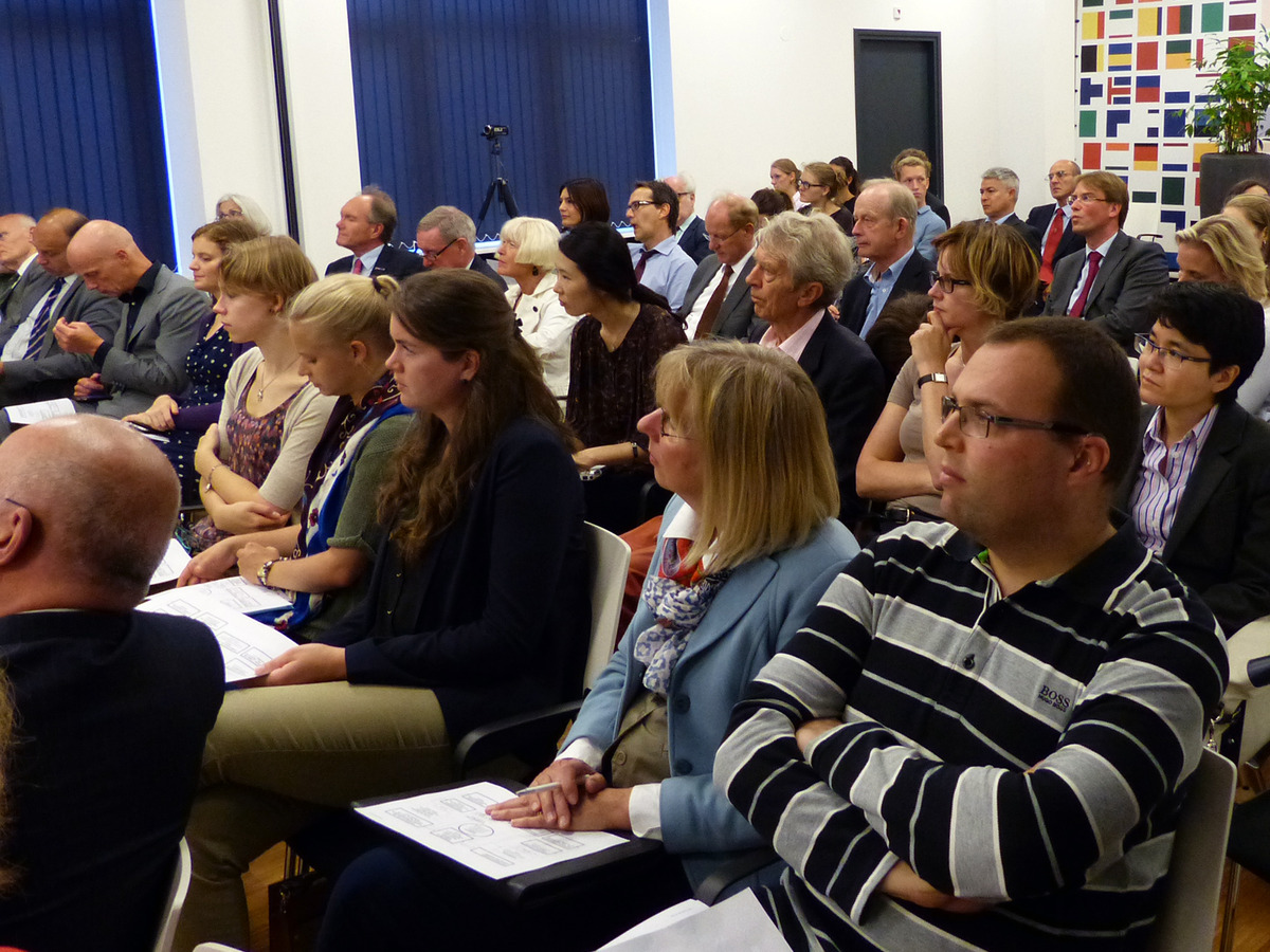 The audience listens attentively